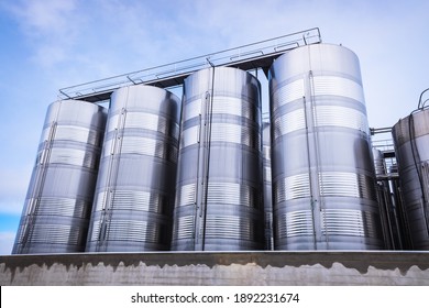 Various silos and vertical metal food tanks for the food industry.