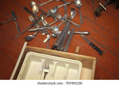 Various Silverware Spread Out On A Kitchen Wooden Floor, Overhead Indoor Photo