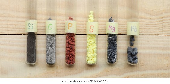 Various simple inorganic substances in test tubes: amorphous silicon, gray carbon, red phosphorus, crystalline yellow sulfur, magnesium shavings, heavy lead.