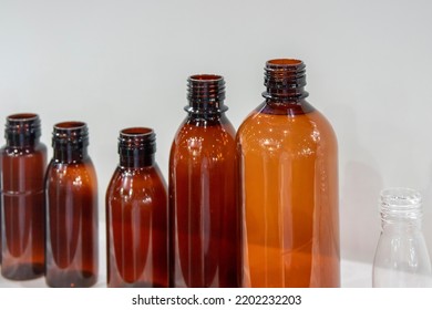 The Various Size Of Brown Bottles Container. The Plastic Bottle Container Manufacturing Process.