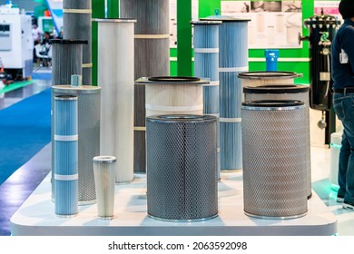 Various size and type air pleated filter paper for cleaning air or gas fluids or remove dust debris contaminants in engine or machine of industrial work on table