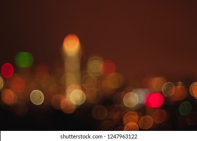 Various sized sharp round bokeh of the city of Seattle skyline at sunset with Space Needle against reddish sky