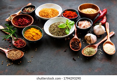 Various spices in a bowls on black concrete background. Top view copy space. - Shutterstock ID 1794293290
