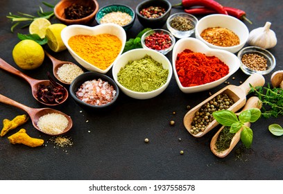 Various spices in a bowls on black concrete background. Top view copy space. - Shutterstock ID 1937558578