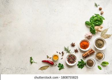 Various Spices, Herbs And Condiments On White Stone Table, Top View, Copy Space. Healthy Cooking, Indian Food Background.