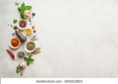 Various Spices, Herbs And Condiments On White Stone Table, Top View, Copy Space. Healthy Cooking, Indian Food Background.