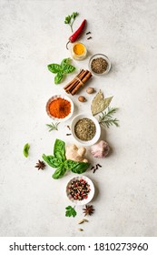 Various Spices, Herbs And Condiments On White Stone Table, Top View, Copy Space. Healthy Cooking, Indian Food Background.