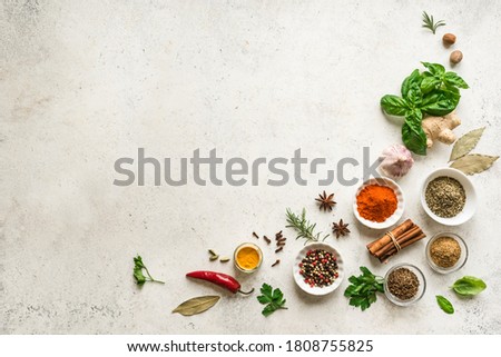 Various Spices, Herbs and Condiments on white stone table, top view, copy space. Healthy cooking, indian food background.