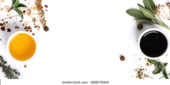 Various spices, herbs, olive oil and balsamic vinegar on a white background top view. Free space for text. Food background, ingredients for cooking.