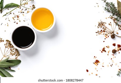 Various spices, herbs, olive oil and balsamic vinegar on a white background top view. Free space for text. Food background, ingredients for cooking.