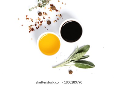 Various spices, herbs, olive oil and balsamic vinegar on a white background top view. Free space for text. Food background, ingredients for cooking. - Powered by Shutterstock