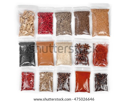 various spices and herbs packed in small transparent plastic bags isolated on white background