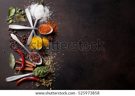 Various spices spoons on stone table. Top view with copy space