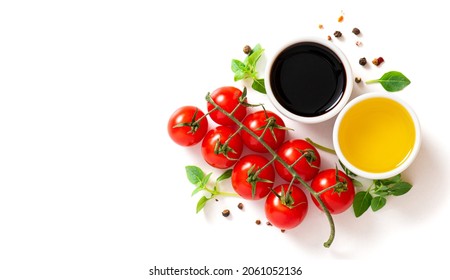 Various spices, tomatoes, olive oil and balsamic vinegar on a white background top view. Free space for text. Food background, ingredients for cooking.