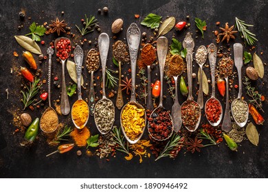 Various spices a vintage spoons on stone table. Colorful Herbal and Spices Oriental marketplace.Top view . Cafe concept. Delicious food delivery.