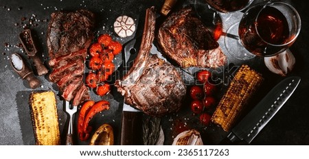 various steaks for a festive dinner for two with glasses of red wine