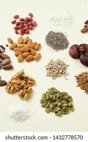 Various superfoods top view. Superfood as coconut powder, spirulina, raw cocoa bean, kerob, walnut, peanut, sunflower and pumpkin seeds