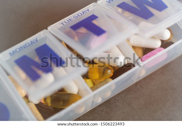 Various Supplements and Vitamins in Plastic Container\
Divided by Day