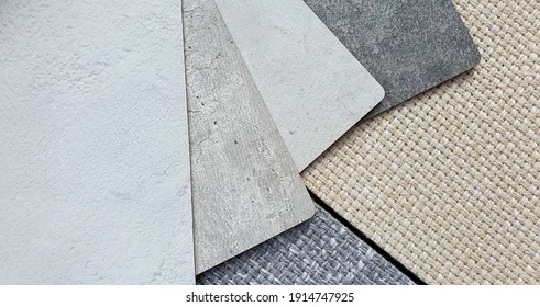 various texture and color of cement or concrete laminated samples isolated on beige and grey sackcloth fabric background with clipping path. interior material combination background for rustic mood.
