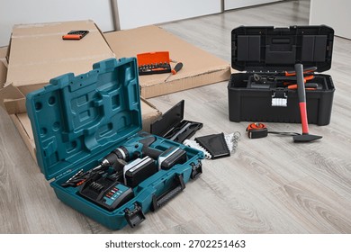 Various tools, including a cordless drill and hammer, ready for furniture assembly or repairs.