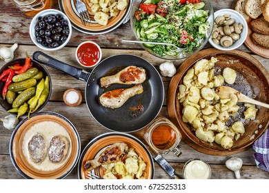 Various Traditional American Snacks With Grilled Chicken Legs And Fried Potatoes On The Dining Table. View From Above. Concept Of Eating Outdoors On A Day Off.