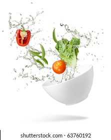 Various Type Of Fresh Vegetables Splashing Out From Spilling Bowl