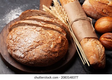 Various types of bread on stone table