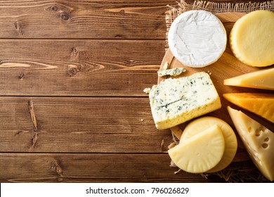 Various types of cheese on dark rustic wooden background. Top view. Copy space. - Powered by Shutterstock