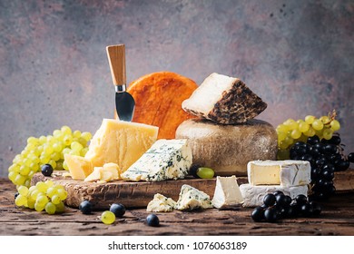 various types of cheese on rustic wooden table