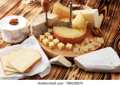 various types of cheese on rustic wooden table. cheese platter