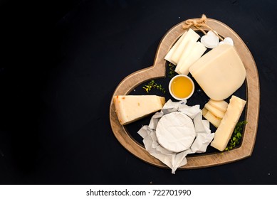 various types of cheese on a stand in the shape of a heart, concept elegant life and love cheese, top view - Powered by Shutterstock