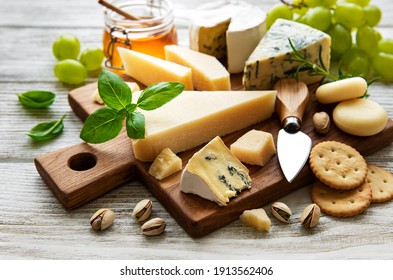 Various types of cheese  on a white wooden background