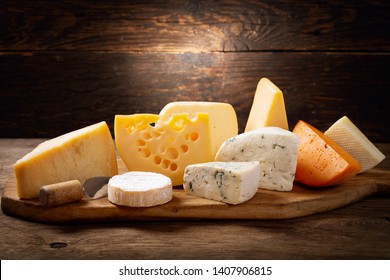 various types of cheese on a wooden board