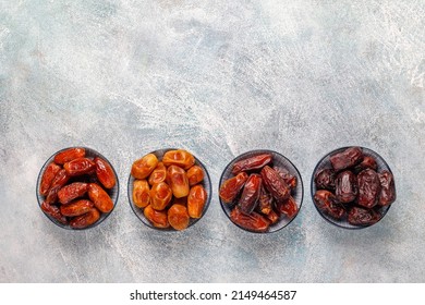 various types of dates in a wooden plate over a burlap bag on the table, in Ramadan the Muslim fasting person breaks his fast with dates, Ajwa Khidri Sokari, Zahidi Kholas, Kalami Mabroom, Safawi.