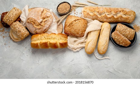 Various types of fresh baked bread on light gray background. Top view, flat lay, copy space - Shutterstock ID 2018156870