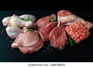 Various Types Of Fresh Meat: Pork, Beef, Turkey And Chicken On A Black Table