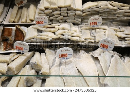Various types of frozen cod (bacalla in Catalan language) at Mercat de Sant Antoni market in Barcelona, Spain.