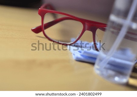 Various types of glasses, with lens cleaning spray and drying cloth