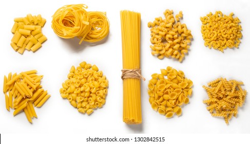Various types of pasta spread out in piles on white. Cooking concept