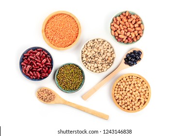 Various types of pulses, shot from the top on a white background. Red kidney, pinto, and black beans, lentils, chickpeas, soybeans, and black-eyed peas - Shutterstock ID 1243146838
