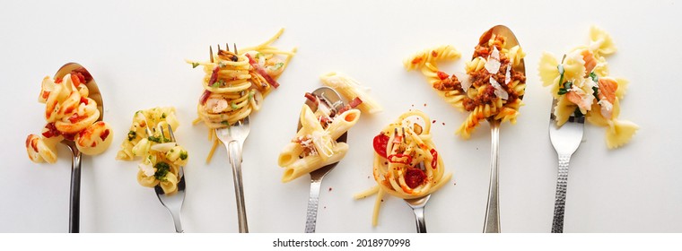 Various types of yummy pasta on spoons and forks (carbonara, spaghetti bolognese, pasta penne arrabiata, fusilli pasta bolognese)