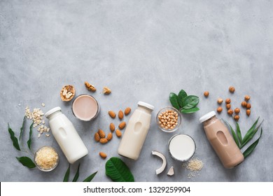 Various vegan plant based milk and ingredients, top view, copy space. Dairy free milk substitute drink, healthy eating. - Shutterstock ID 1329259904