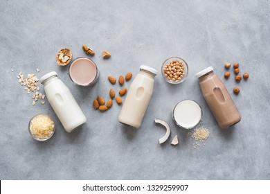Various vegan plant based milk and ingredients, top view, copy space. Dairy free milk substitute drink, healthy eating. - Shutterstock ID 1329259907