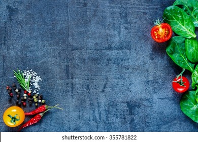 Various Vegetarian Ingredients (spinach, Tomatoes, Spices And Herbs) On Dark Vintage Table, Top View. Healthy Food, Vegan Or Diet Nutrition Concept. Background Layout With Free Text Space.