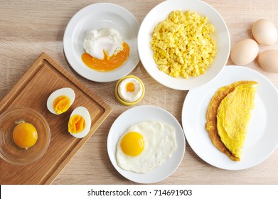 Various ways of cooking chicken eggs. Omelette, poached, soft-boiled, hard-boiled, fried, scrambled eggs.  Top view. Close-up.