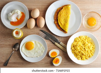Various ways of cooking chicken eggs. Omelette, poached, soft-boiled, hard-boiled, fried, scrambled eggs.  Top view. Close-up.