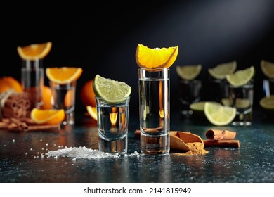 Various ways of using tequila. Tequila with lime and salt and tequila with orange and cinnamon.