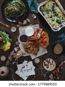 Various Western Food Dishes Flatlay. Quarantine Meal At Home. Dark Food Photography, Rustic, Still Life. Chicken Waffles Top Down Shot.