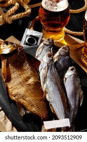 Various Whole Air-dried And Smoked Fish Served With Amber Lager