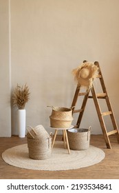 Various wicker baskets for interior decoration stand on the floor in a modern living room.